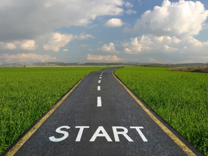 road through a field with the word start