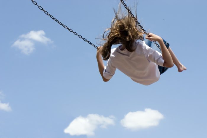 Girl swinging high in the air