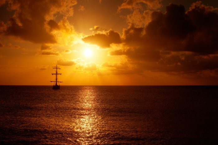 ship sailing into the sunset