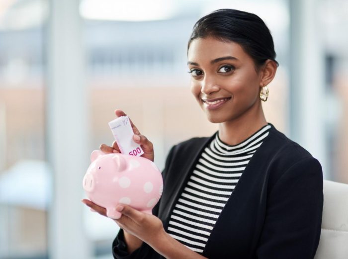 Woman saving in piggy bank