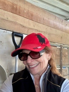 Teri mucking out her horse's stall